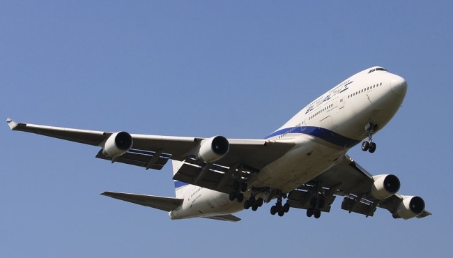 a boeing 747 jet passenger aircraft on takeoff with a blue sky in the background
